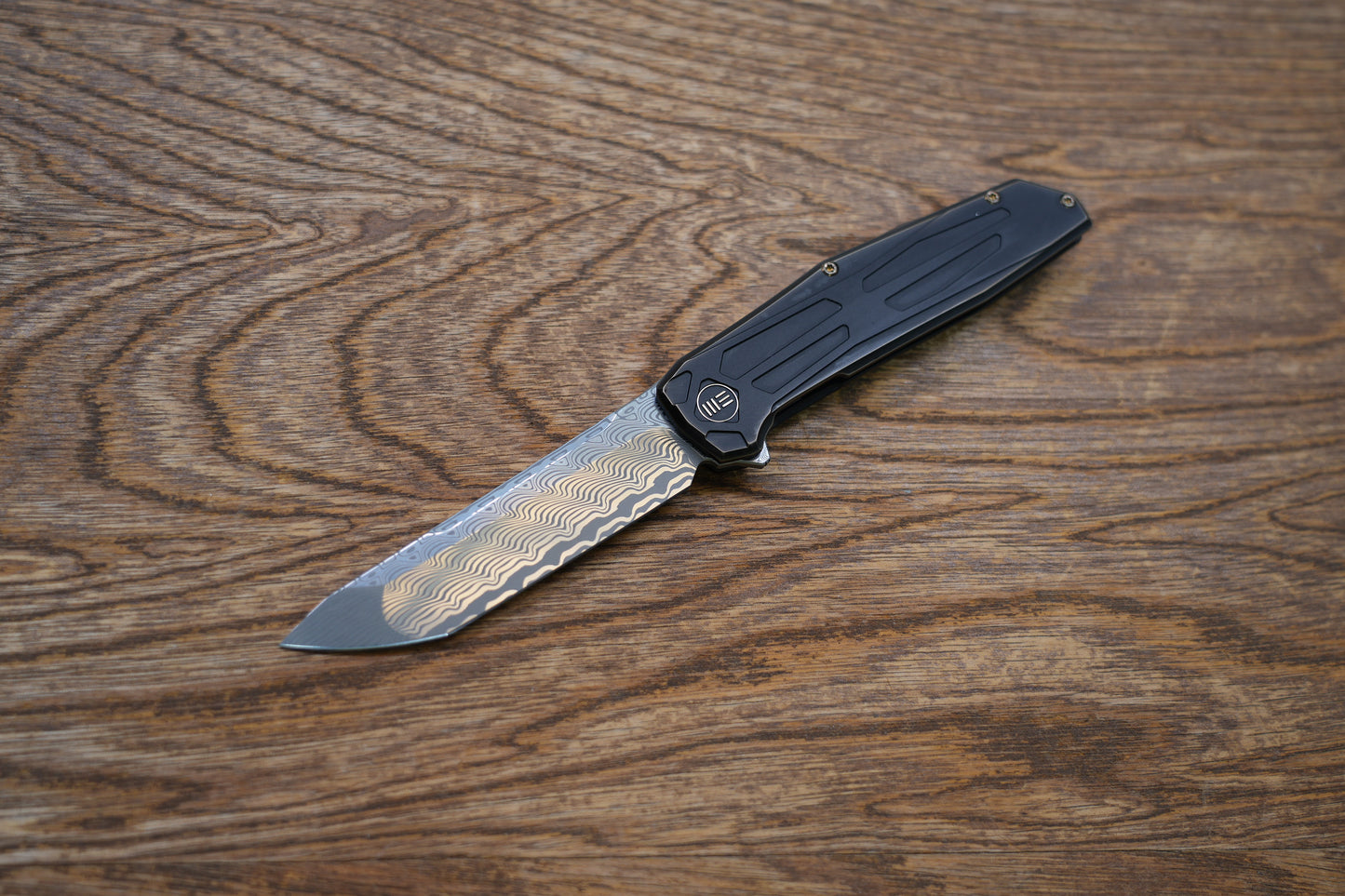 We Knife Company Rafal Brzeski Shadowfire Flipper Knife 3.97" Hakkapella Damasteel Tanto Blade, Bronze/Black Titanium Handles, Frame Lock - WE22035-DS1