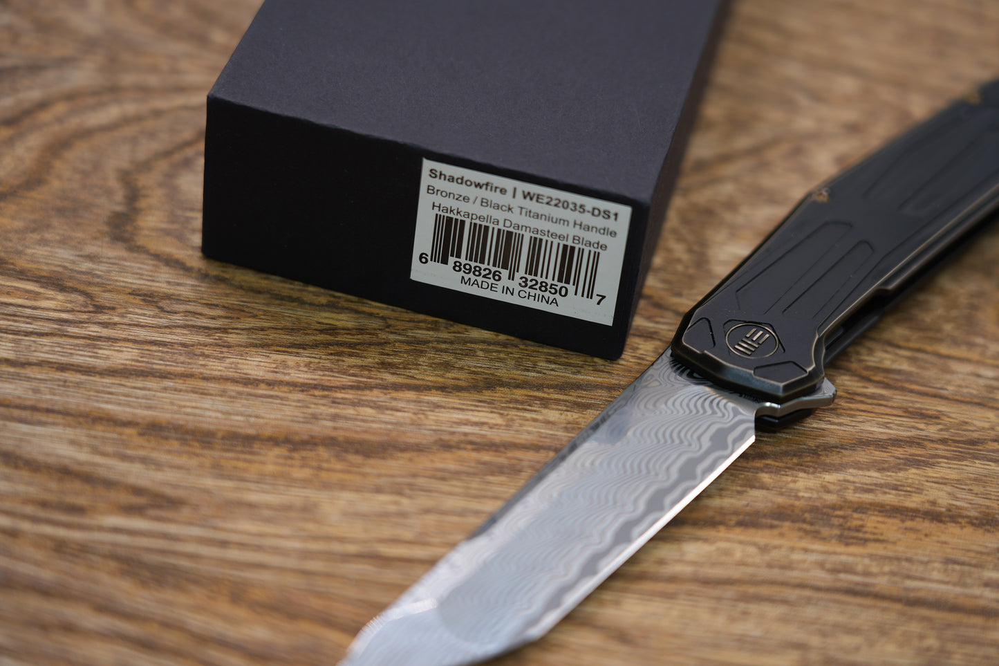 We Knife Company Rafal Brzeski Shadowfire Flipper Knife 3.97" Hakkapella Damasteel Tanto Blade, Bronze/Black Titanium Handles, Frame Lock - WE22035-DS1